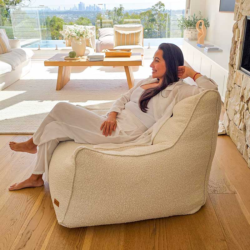 Contemporary neutral space featuring the Cream Bouclé Serena modern bean bag chair with adult seated.