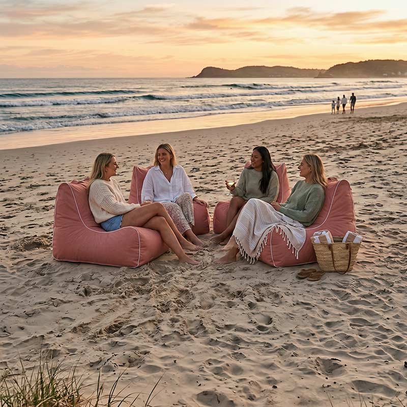 Lifestyle Image: Blush Solid Bora Bora Bean Bag chairs on the bean with 4 girls sitting on them in total comfort. Take outdoor comfort everywhere with you.