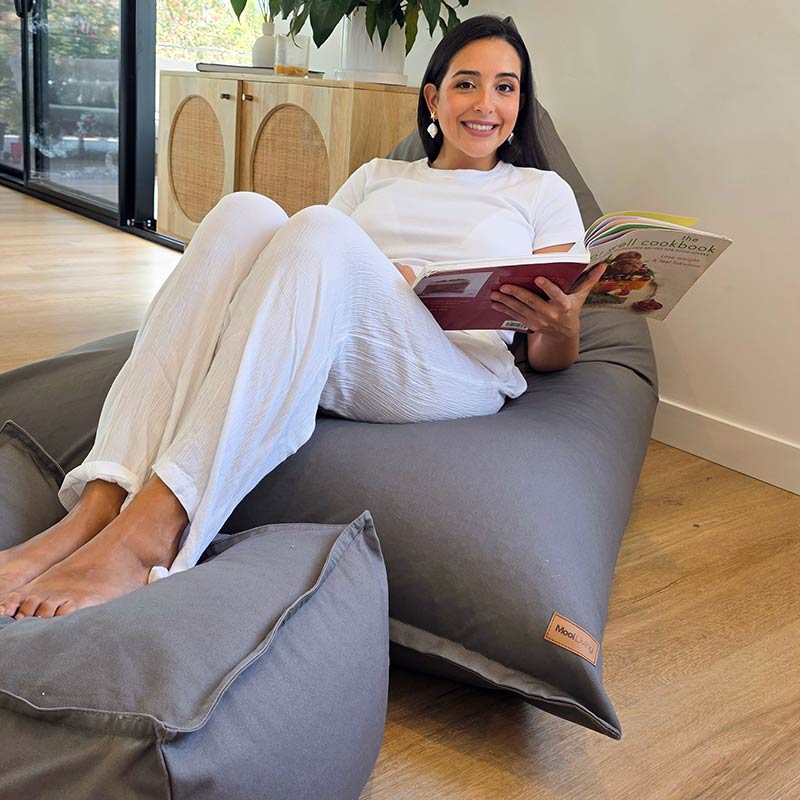 Mocha large Cotton Canvas Triangle Bean Bag Chair by Mooi Living paired with coordinating canvas ottoman in a contemporary living room. Ottoman sold separately.