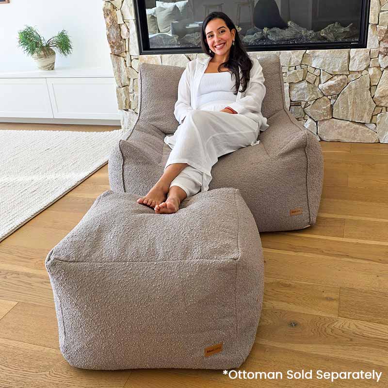 Taupe Bouclé Serena Armchair Bean Bag with coordinating ottoman by Mooi Living in a contemporary living room.