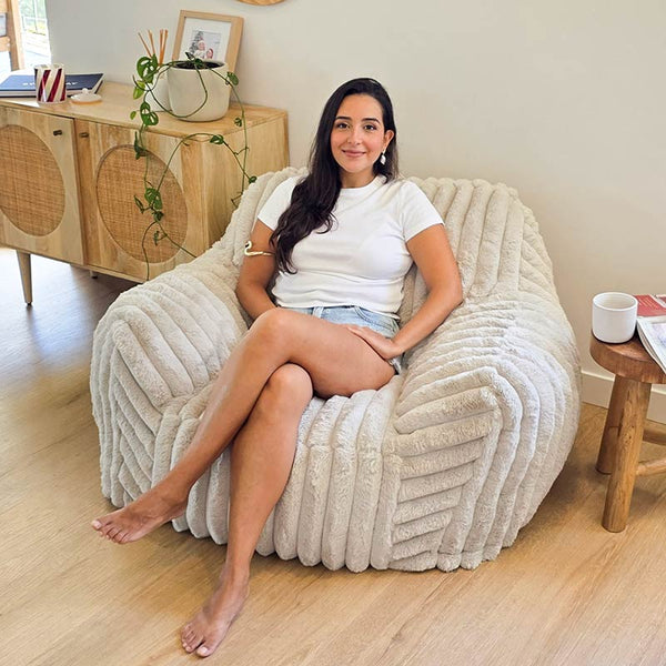 Callie Corduroy Faux Fur Armchair  Foam Filled bean bag by Mooi Living in a neutral living room, woman seated.