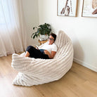 Oversized champagne Cloud Bean Bag mat with woman relaxing and reading indoors