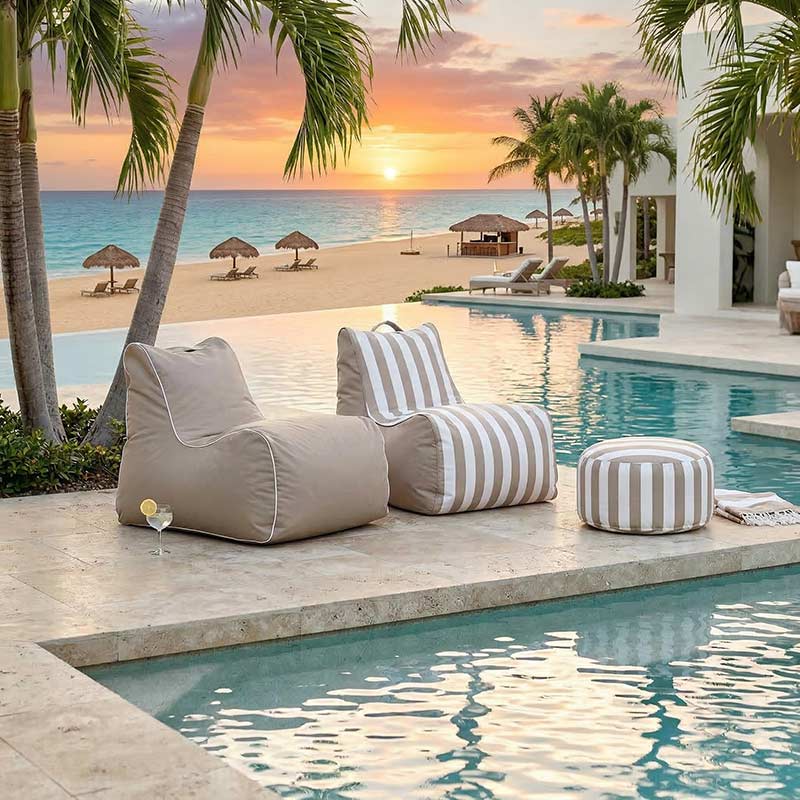 Lifestyle Image - a Taupe Solid and Taupe Stripe Bora Bora outdoor bean bag chair located at a tropical resort.