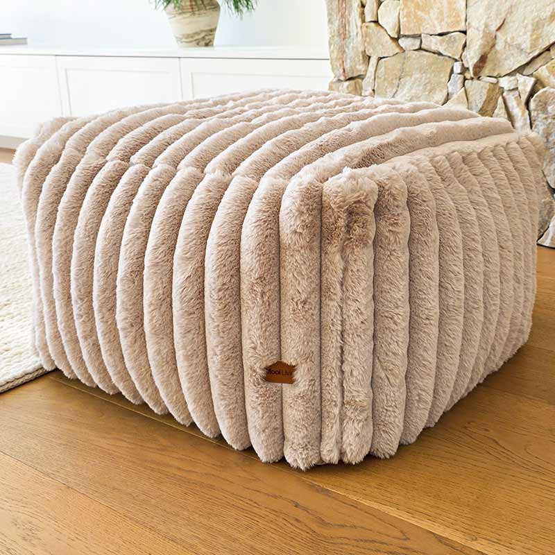 Callie Corduroy Ottoman by Mooi Living in ribbed cord fabric, styled as a footrest in a modern interior.