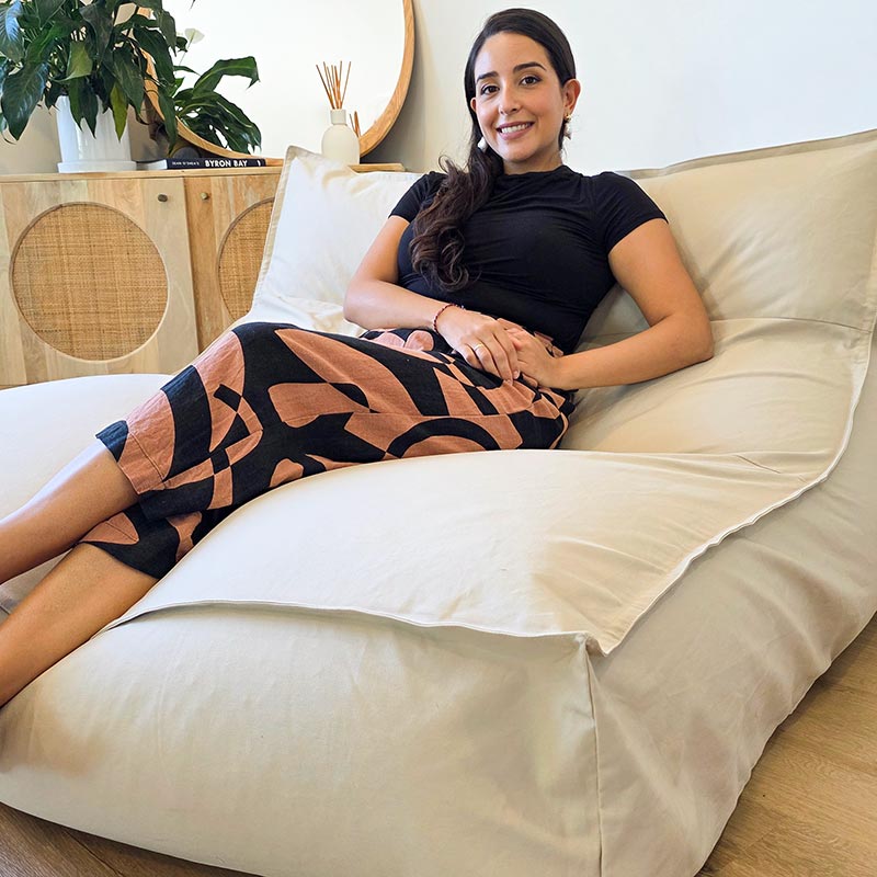 Natural Double Boss large two person indoor bean bag styled in a neutral Australian home, with lady comfortably seated on the bean bag lounger.