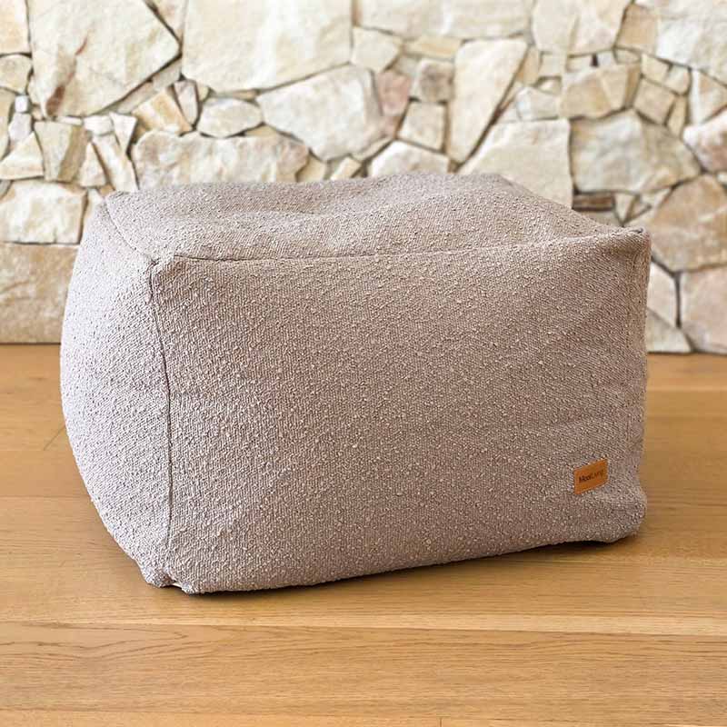 Taupe Serena bouclé ottoman designed to coordinate with the Serena Armchair by Mooi Living.