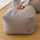 Taupe bouclé Serena ottoman indoor bean bag by Mooi Living with textured upholstery.