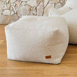Cream Serena bouclé ottoman designed to pair with the Serena Armchair by Mooi Living.