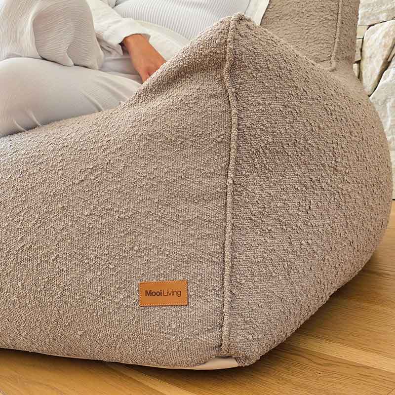 Close shot of Taupe Bouclé Serena Armchair by Mooi Living in a contemporary living room.