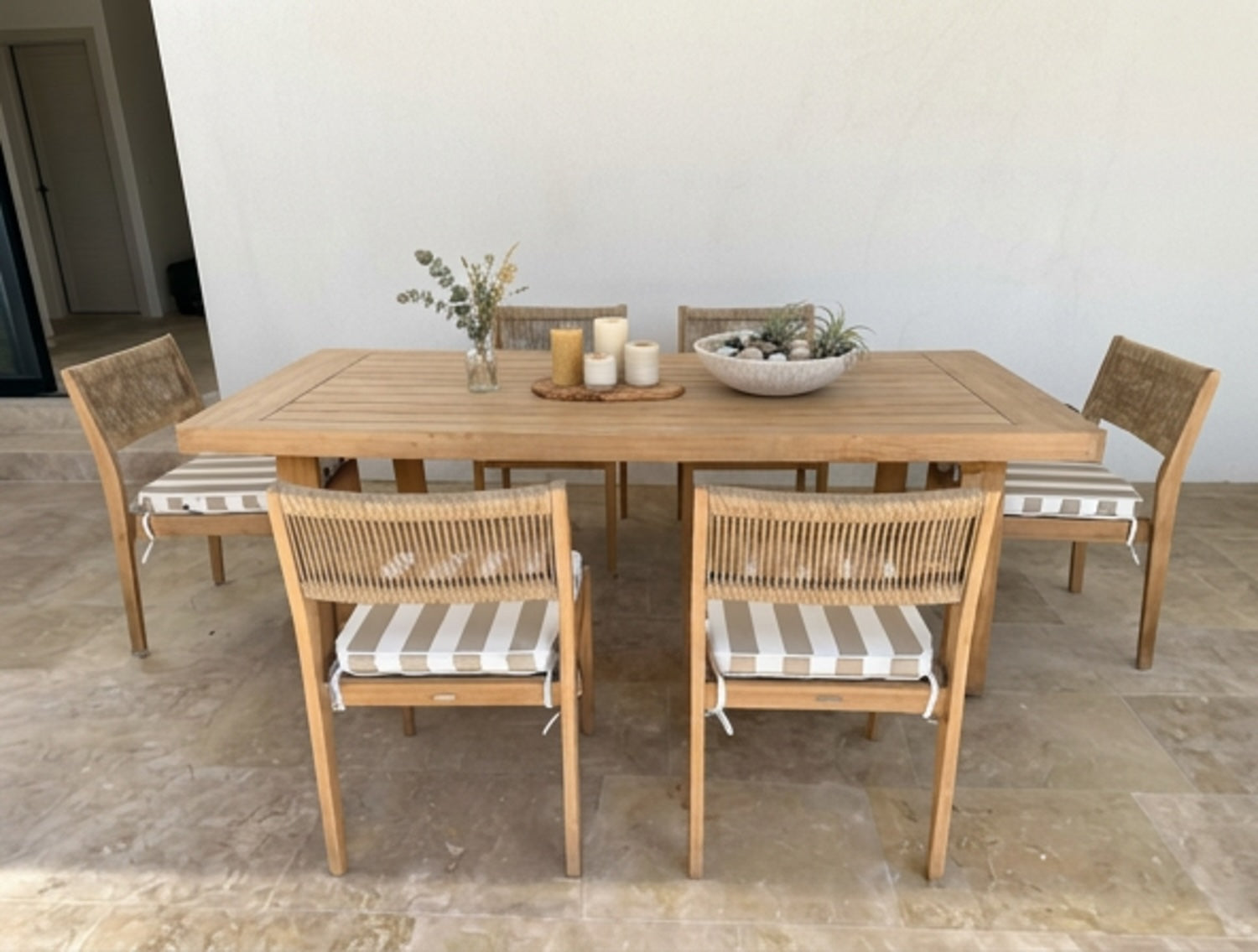 A 7-piece outdoor dining set featuring a rectangular light oak wood table and six matching armchairs with taupe and white striped chair cushions by Mooi Living, MOO-STR-TAU-CHPAD