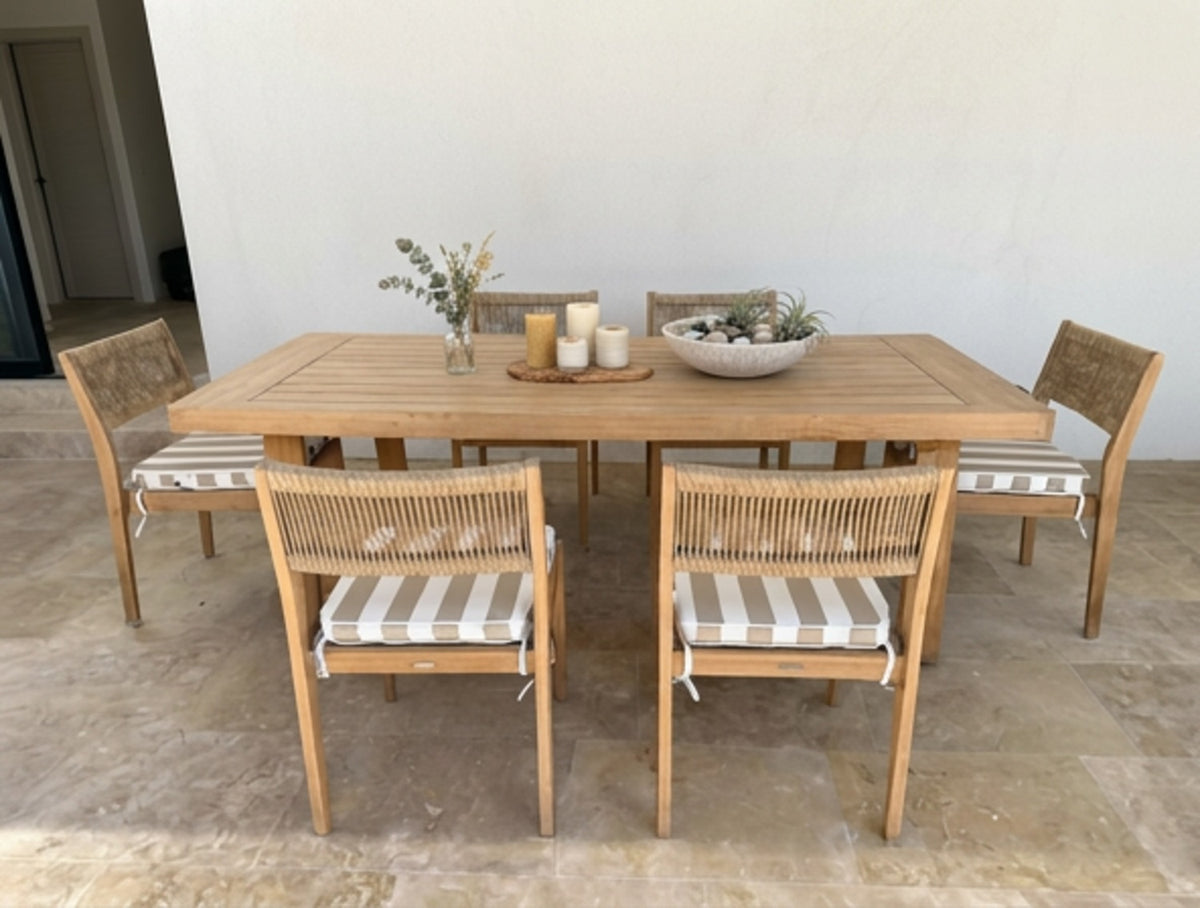 A 7-piece outdoor dining set featuring a rectangular light oak wood table and six matching armchairs with taupe and white striped chair cushions by Mooi Living, MOO-STR-TAU-CHPAD