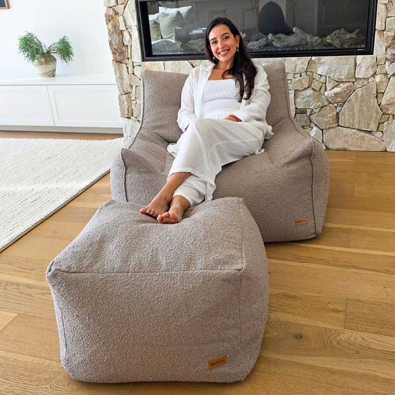 Serena bouclé armchair in Taupe indoor bean bag by Mooi Living with a separate coordinating ottoman.